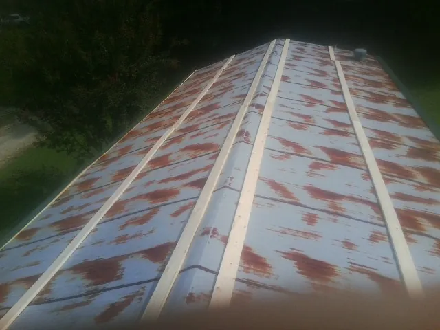 Rusted metal roof panels with new wood purlins before replacement — Storm Damage Roof Repair in Harwich by Roofing Brothers